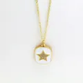 Close-up of a gold star pendant necklace with white enamel background and sparkling crystals - Five-pointed Star