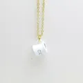 Detailed macro view of white enamel coffee cup pendant on a delicate gold chain necklace - White
