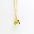 Detailed close-up of a gold-plated coffee cup pendant necklace with engraved lettering - Gold Color