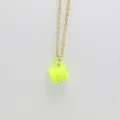 Macro detail shot showing neon yellow drip oil coffee cup pendant on thin gold link chain - Yellow
