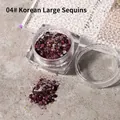 Chunky burgundy nail art glitter sequins color 04 in clear jar on textured surface - Korean Sequin (04) / 04 Dark Magenta