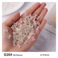 Hand holding iridescent aurora resin mini bows for nail art decoration, 50 pieces pack - 50 Pieces/Pack (11*8.4mm)
