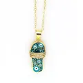 Macro detail view of a gold-plated evil eye slipper pendant with enamel and rhinestones - Blue