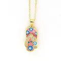 Close-up detail of gold slipper necklace with pink enamel drip oil and blue evil eye - Pink