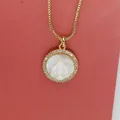 Close-up of golden circular pendant featuring a carved Virgin Mary shell center and zircons - Virgin Mary Portrait White Zirconia (a5)