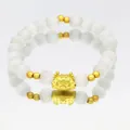 Detailed view of elegant white cat's eye stone bracelet featuring a golden dragon charm. - Cat-eye Stone Bracelet / White