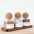 Set of 3 glass storage jars with cork lids on an acacia tray for coffee and tea - Set