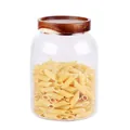 High borosilicate glass storage jar with an airtight acacia wood lid and penne pasta - 40oz