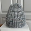 Detailed macro view of slouchy knitted beanie hat in grey with sparkly gold accents - M (56-59cm) / Mixed Grey