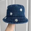Close-up of blue denim bucket hat with silver embroidered shell patterns for summer - Dark Blue Shell