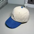 Detailed close-up of a two-tone corduroy baseball cap with beige crown and blue brim. - M (56-58cm) / Royal Blue and Beige Colorblock