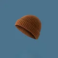 Close-up of a brown ribbed knit beanie cap with a classic street style melon shape. - Elastic Adjustable / Caramel color