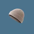 Macro view of beige ribbed knit beanie hat showing soft fabric and detailed texture - Elastic Adjustable / Beige