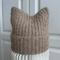 Close-up of a cozy brown knitted beanie with cute cat ears and chunky rib texture - M (56-58cm) / Khaki