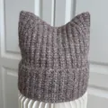Detail of a cozy brown knitted beanie with cute cat ears featuring soft ribbed texture - M (56-58cm) / Mocha