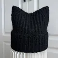 Detailed view of a black fuzzy knitted beanie with cute cat ears and ribbed texture - M (56-58cm) / Black