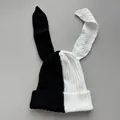 Close-up view of the black and white split knit beanie featuring long rabbit ears - M (56-59cm) / Black and White Patchwork