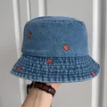 Close-up of blue denim bucket hat featuring high-quality red strawberry embroidery - Medium Blue Small Strawberry