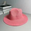 Side view detail of a pink woven Panama straw hat on a neutral background - One Size Adjustable / Plain / Girl Pink