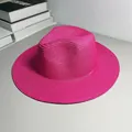 Close-up of a pink woven Panama straw hat with a wide brim and jazz fedora shape - One Size Adjustable / Plain / Rose Red