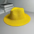 Detailed view of a vibrant yellow straw Panama hat with a textured weave and jazz brim. - One Size Adjustable / Plain / Yellow