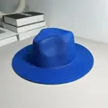 Detailed macro shot of a vibrant blue straw Panama hat with classic Jazz style brim. - One Size Adjustable / Plain / Sapphire Blue
