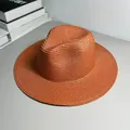 Detail view of the fine woven texture on a stylish orange Panama sun hat for beach - One Size Adjustable / Plain / Caramel color