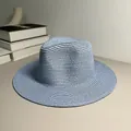 Detail of light blue woven Panama straw hat with a wide brim for sun protection. - One Size Adjustable / Plain / Sky Blue
