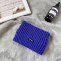 Primo piano della fascia in maglia blu con dettaglio patch su pelliccia sintetica - Blu Zaffiro