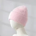 Close-up detail of soft pink rabbit hair knitted beanie hat shown on a white mannequin head - Girl Pink