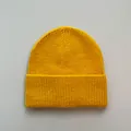 Close-up of mustard yellow knitted beanie showing soft imitation cashmere texture. - One Size / Yellow
