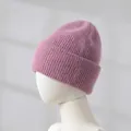 Close-up detail of a soft pink rabbit fur knit beanie hat featuring thick texture for winter warmth - Rose Purple