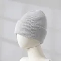 Detail view of the soft grey rabbit hair knitted beanie with ribbed texture and thick roll edge - Ash Gray