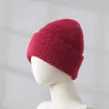 Thick red knitted rabbit hair beanie shown on a mannequin head for winter warmth - Burgundy