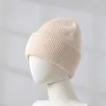 Close-up of beige rabbit hair knitted beanie on mannequin head, showing soft texture. - Apricot