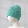 Close-up detail of a soft mint green rabbit fur knitted beanie showing ribbed texture - Lake Green