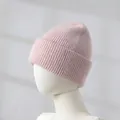 Detailed close-up of a soft pink rabbit hair blend knitted beanie on a white mannequin head - Lotus Pink