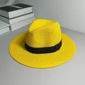 Close-up detail of a bright yellow Panama straw hat with a classic black ribbon band. - One Size Adjustable / Ribbon Style (Detachable Ribbon) / Yellow