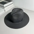 Detailed view of classic black woven Panama straw hat featuring an elegant matching ribbon band. - One Size Adjustable / Ribbon Style (Detachable Ribbon) / Black