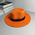 Detailed view of a vibrant orange straw Panama hat featuring a stylish black ribbon band. - One Size Adjustable / Ribbon Style (Detachable Ribbon) / Orange