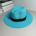 Detailed view of a vibrant turquoise Panama straw hat featuring a classic black ribbon band. - One Size Adjustable / Ribbon Style (Detachable) / Lake Blue
