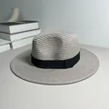 Classic grey straw Panama fedora hat with black ribbon detail on a minimalist desk - One Size Adjustable / Ribbon Style (Detachable) / Gray