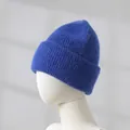 Macro view of soft blue knit beanie texture with thick folded brim on white mannequin - Sapphire Blue