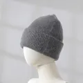 Detailed macro view showing the fuzzy texture of a gray rabbit hair winter knit beanie. - Graphite