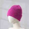 Detailed macro view of magenta rabbit hair knitted beanie worn on white mannequin head - Rose Red