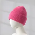 Close-up detail of a soft pink rabbit hair knitted beanie displayed on a mannequin - Rose Pink