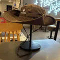 Close-up of a stylish brown outdoor sun hat with TICALBIRD embroidery on a display stand - M (56-58cm) / Brown