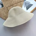 Detailed view of the minimalist woven texture on a foldable straw beach bucket hat. - Adjustable (56-58cm) / Beige
