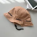 Detail view showing the sturdy drawstring design of this retro khaki dual-use bucket hat - Reversible / Khaki
