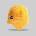 Close-up of yellow knit earflap beanie with snowflake tag detail - Elastic Circumference (56-59cm) / Yellow